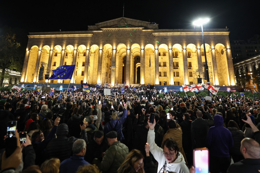 Georgian opposition supporters rally to protest results of the parliamentary elections that showed a win for the ruling Georgian Dream party, outside the parliament building in central Tbilisi on October 28, 2024. (Photo by Giorgi Arjevanidze / AFP)