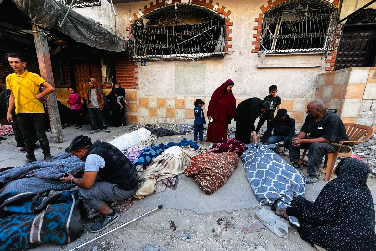 Palestinians mourn over the bodies of relatives after an Israeli strike in Beit Lahia, in the northern Gaza Strip, on October 29, 2024. Photo by AFP.