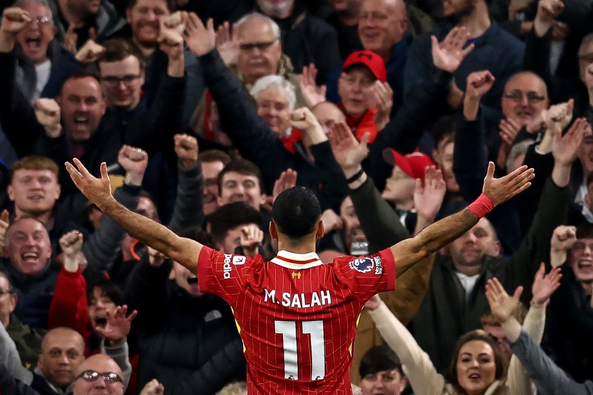 Liverpool's Egyptian striker #11 Mohamed Salah celebrates scoring the team's second goal during the English Premier League football match between Liverpool and Brighton and Hove Albion at Anfield in Liverpool, north west England on November 2, 2024. (Photo by Darren Staples / AFP)