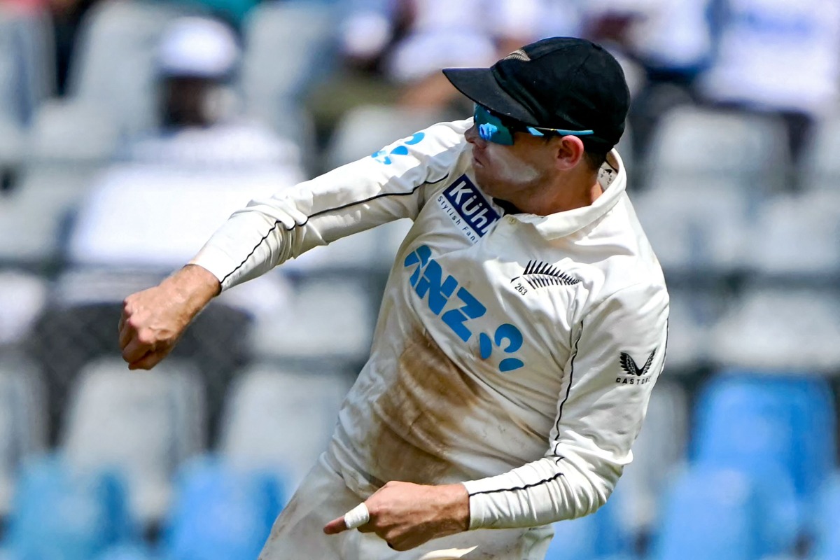 New Zealand's captain Tom Latham throws the ball during the third day of the third and final Test cricket match between India and New Zealand at the Wankhede Stadium in Mumbai on November 3, 2024. (Photo by INDRANIL MUKHERJEE / AFP)