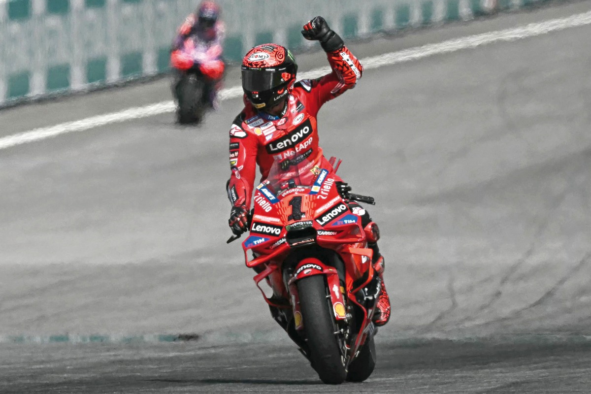 Ducati Lenovo Team’s Italian rider Francesco Bagnaia celebrates as he crosses the finish line to win the MotoGP Malaysian Grand Prix.