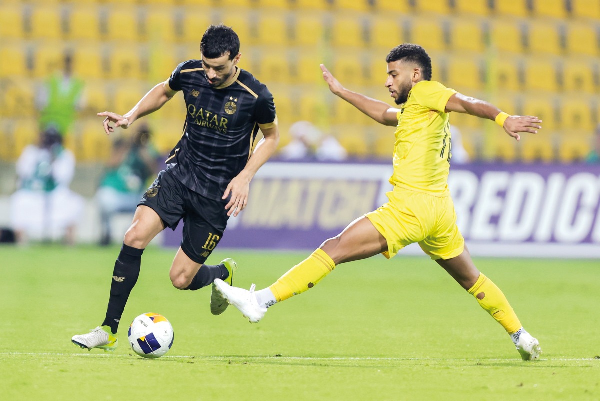 Al Sadd's Boualem Khoukhi (left) vies for the ball with an Al Wasl player.