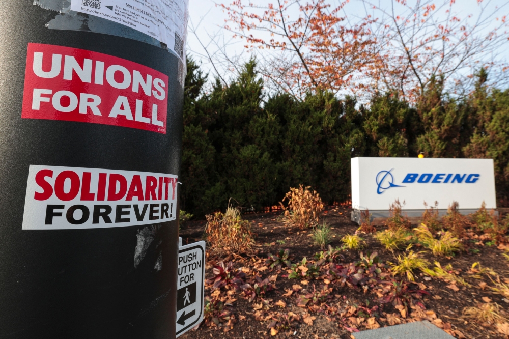 Pro-union stickers are pictured on a pole outside the Boeing Renton Production Facility one day before striking union members will vote on a new contract offer in Renton, Washington on November 3, 2024. (Photo by Jason Redmond / AFP)