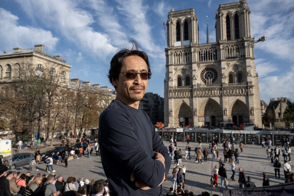 Japanese organ builder Itaru Sekiguchi, currently working on the harmonisation of the Cathedral organ, poses during a photo session in front the Notre-Dame de Paris Cathedral in Paris, on October 24, 2024. Photo by BERTRAND GUAY / AFP