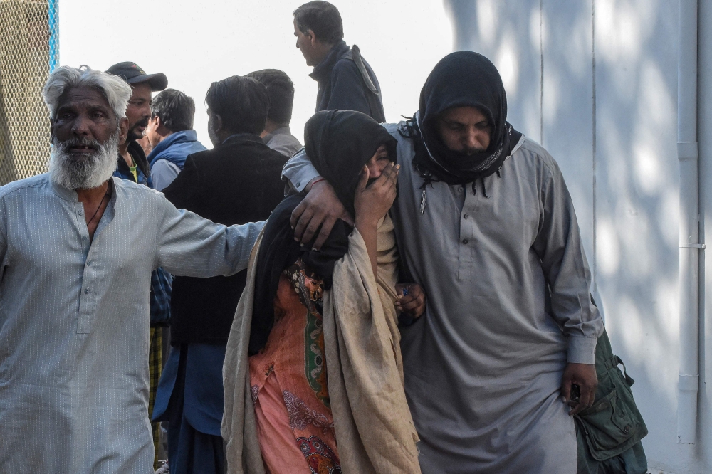 Families mourn the death of their relatives outside a hospital following a bomb blast at a railway station in Quetta on November 9, 2024. (Photo by Banaras Khan / AFP)