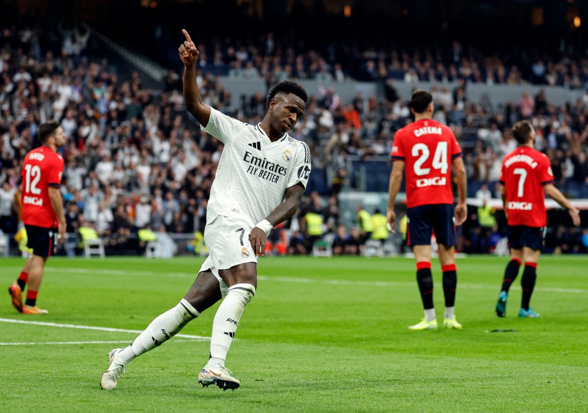 Real Madrid's Brazilian forward #07 Vinicius Junior celebrates scoring his team's first goal during the Spanish league football match between Real Madrid CF and CA Osasuna at the Santiago Bernabeu stadium in Madrid on November 9, 2024. (Photo by OSCAR DEL POZO / AFP)
