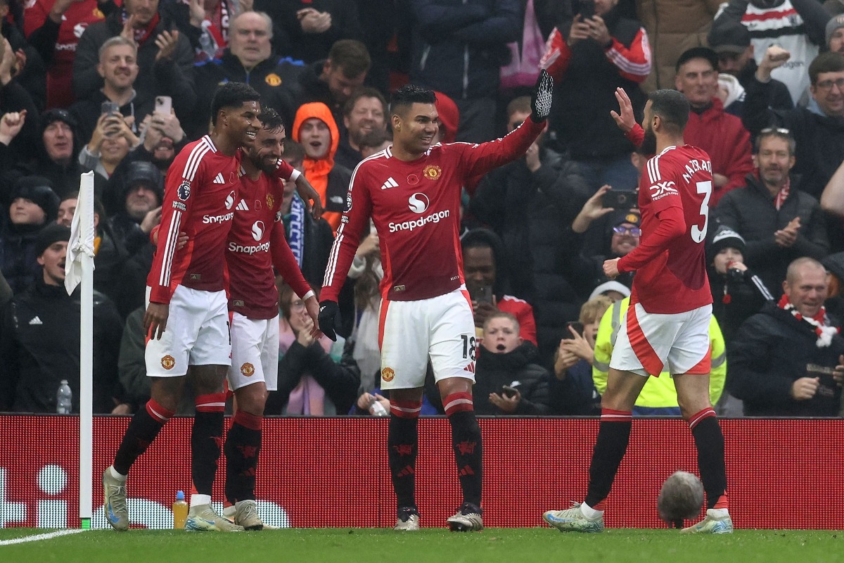 Manchester United's English striker #10 Marcus Rashford, Manchester United's Portuguese midfielder #08 Bruno Fernandes, Manchester United's Brazilian midfielder #18 Casemiro and Manchester United's Moroccan defender #03 Noussair Mazraoui celebrate their second goal during the English Premier League football match between Manchester United and Leicester City at Old Trafford in Manchester, north west England, on November 10, 2024. (Photo by Darren Staples / AFP) 