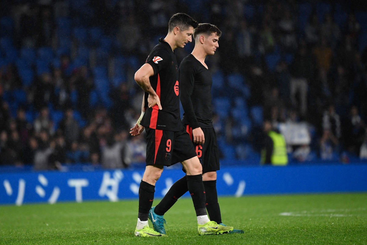 Barcelona's Polish forward #09 Robert Lewandowski (L) and Barcelona's Spanish midfielder #06 Pablo Gavi react after the Spanish league football match between Real Sociedad and FC Barcelona at the Anoeta stadium in San Sebastian on November 10, 2024. (Photo by ANDER GILLENEA / AFP)
