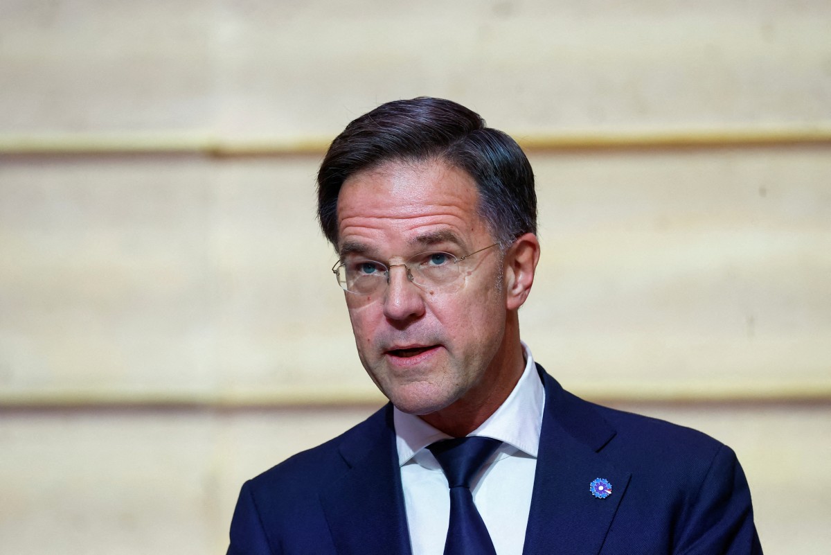 NATO Secretary General Mark Rutte delivers a statement as the French President listens on, during their meeting at The Elysee Palace, in Paris on November 12, 2024. Photo by Manon Cruz / POOL / AFP.