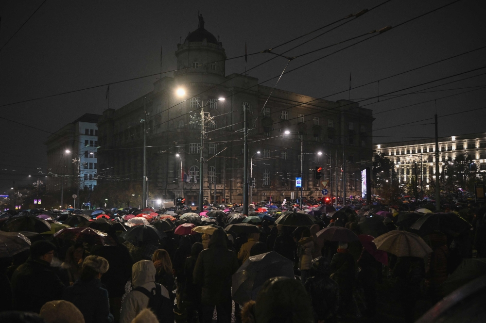 People gather in front of the Government building during a protest origanized by the opposition to demand the resignation of Prime Minister Milos Vucevic, ten days after the death of 14 people in a deadly collapse at a train station, in Belgrade on November 11, 2024. (Photo by Andrej ISAKOVIC / AFP)