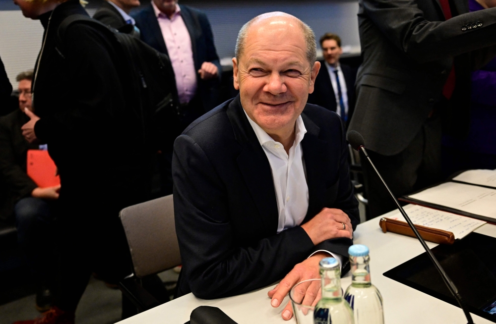 Germany's Chancellor Olaf Scholz takes his seat prior a SPD parliamentary group meeting at the Bundestag, Germany's lower house of parliament in Berlin, on November 12, 2024. (Photo by John MacDougall / AFP)