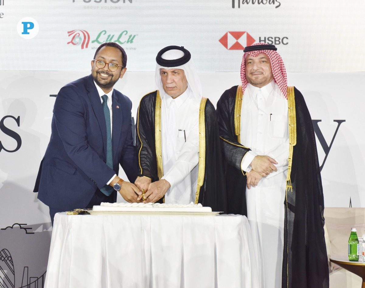 Minister of State for Foreign Affairs H E Sultan bin Saad Al Muraikhi (centre), British Ambassador to Qatar H E Neerav Patel (left), and Director of the Protocol Department at the Ministry of Foreign Affairs H E Ibrahim Yousif Abdullah Fakhro cutting the ceremonial cake of His Majesty King Charles III’s birthday celebrations in Doha yesterday. Pic:  Salim Matramkot / The Peninsula