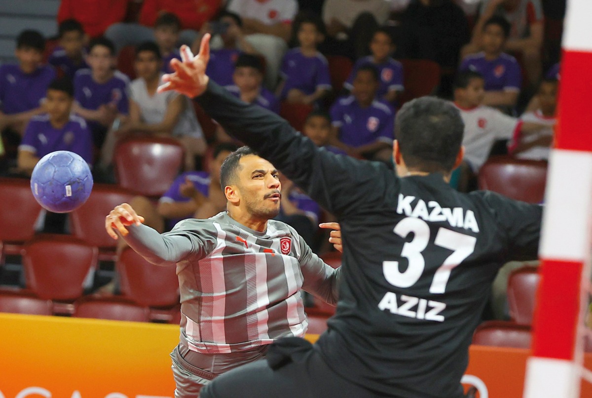 An Al Duhail player shoots at the goal to score during the match against Kazma SC.