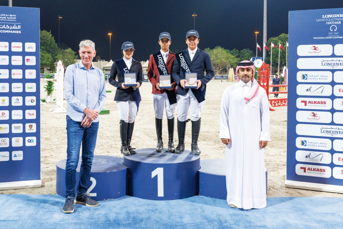 The podium winners of the Small Tour pose for a photo with  officials.