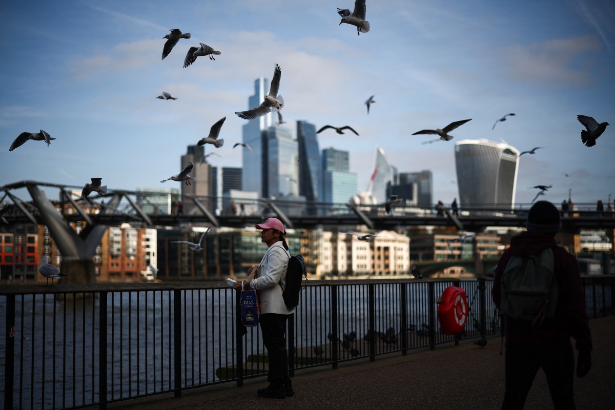 Photo used for demonstration purposes. Seagulls fly over people walking on the Southbank of the River Thames backdropped by the business and financial district in central London on November 15, 2024. Photo by HENRY NICHOLLS / AFP.