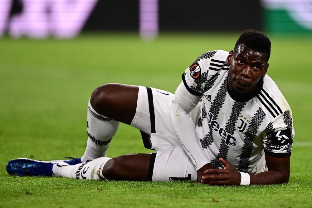 File: Juventus' French midfielder Paul Pogba reacts after being tackled during the UEFA Europa League semi-final first leg football match between Juventus and Sevilla on May 11, 2023 at the Juventus stadium in Turin. (Photo by Marco Bertorello / AFP)