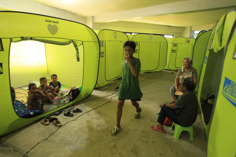 Residents from coastal areas take shelter on an evacuation center in Legaspi City, Albay province, south of Manila on November 16, 2024, ahead of Super Typhoon Man-yi's landfall. (Photo by Charism Sayat / AFP)