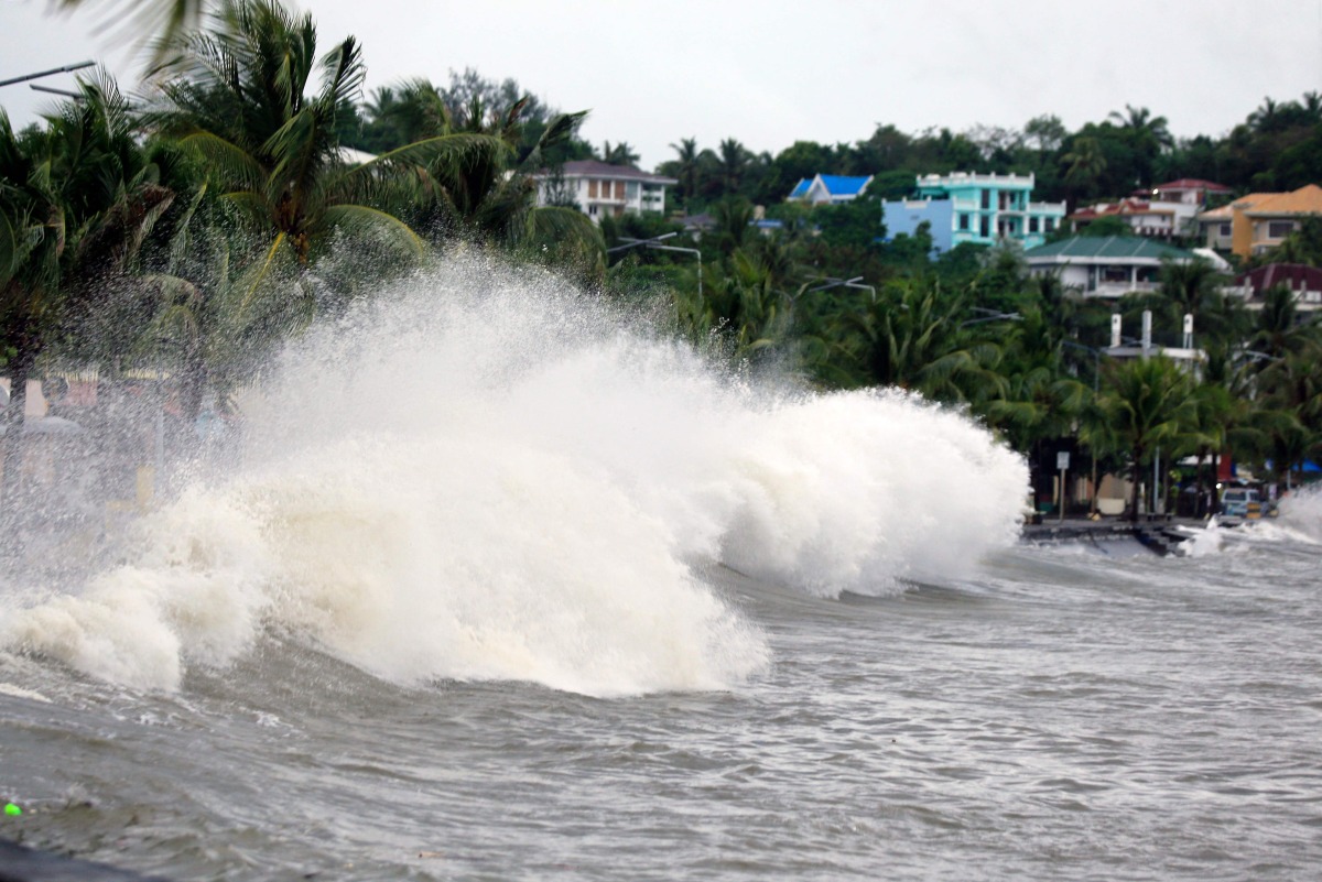 Large waves break along a seawall ahead of the expected landfall of Super Typhoon Man-yi, in Legaspi City, Albay province on November 16, 2024. (Photo by CHARISM SAYAT / AFP)
