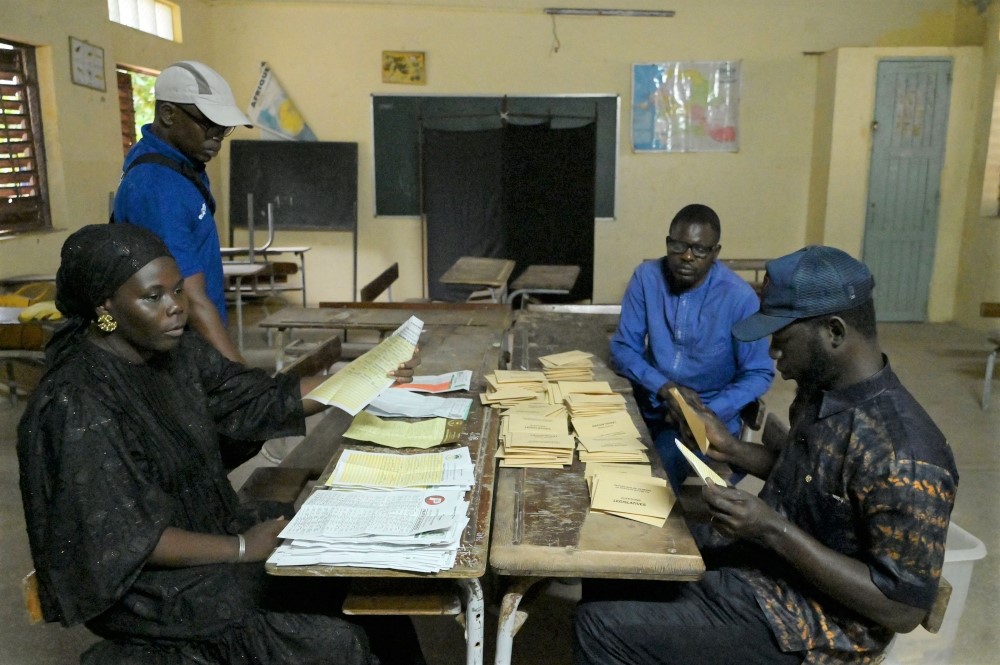 Election officials count ballots, as part of the parliamentary elections, at a voting center in Diamalaye, a neighborhood in Dakar on November 17, 2024. (Photo by Seyllou / AFP)