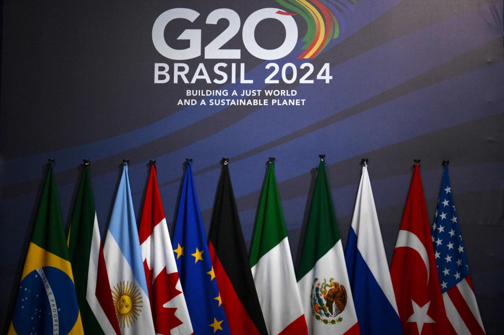 (L-R) National flags of Brazil, South Africa, Argentina, Canada, the European Union, Germany, Italy, Mexico, Russia, Turkiye, and the United States are seen at the media center in the MAM Modern Art Museum ahead of the G20 Summit in Rio de Janeiro, Brazil, on November 17, 2024. (Photo by Luis Robayo / AFP)