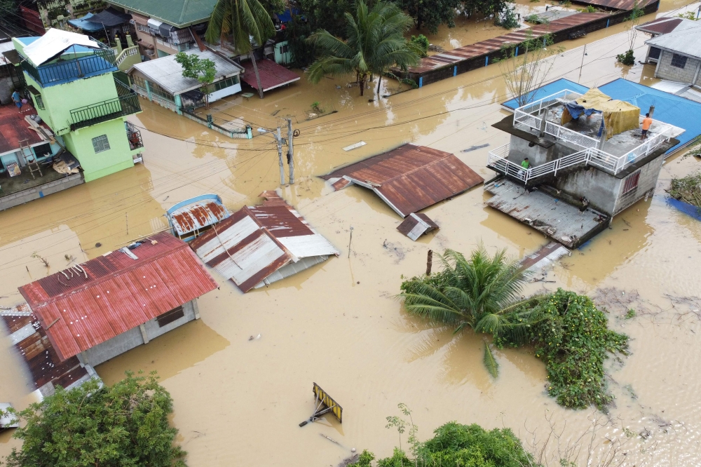 An aerial view shows submerged homes at a village in Ilagan, Isabela province on November 18, 2024, due to continuous heavy rains from Super Typhoon Man-yi. (Photo by Villamor Visaya / AFP