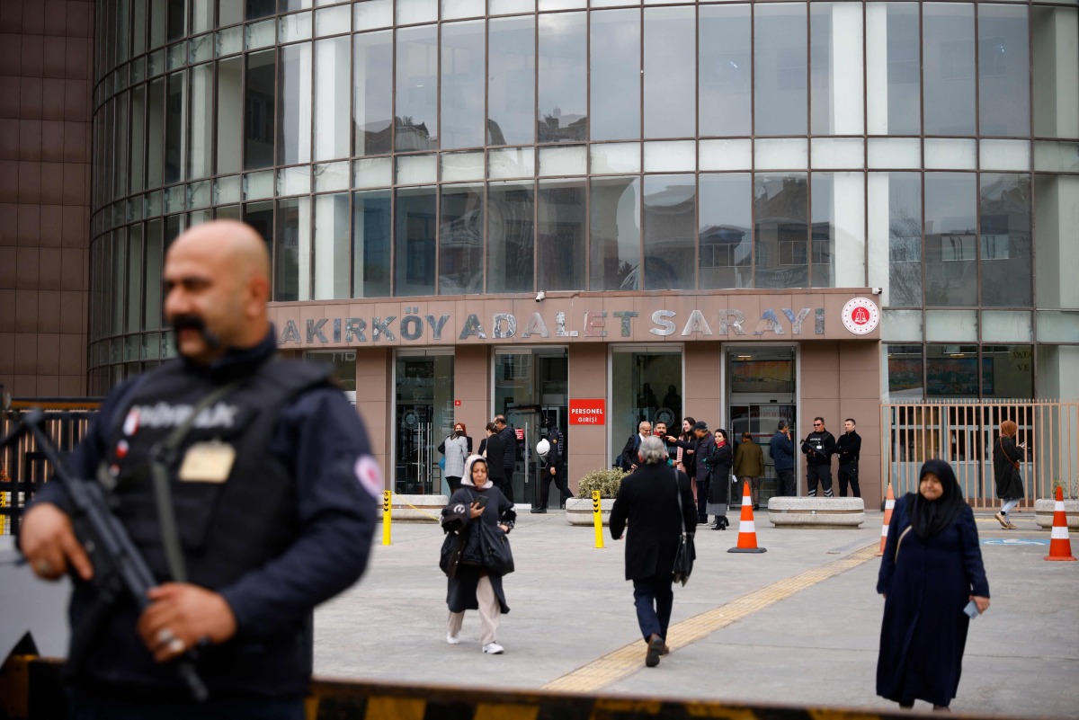 A security member stands guard in front of the Bakirkoy courthouse, on the opening day of Turkey's newborn gang trafficking case trial, in Istanbul, on November 18, 2024. (Photo by KEMAL ASLAN / AFP)
