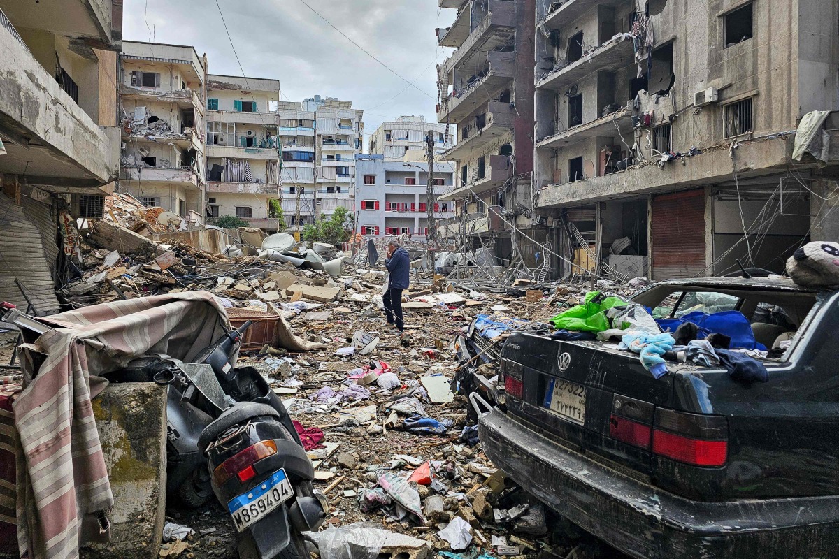 A man walks amid destruction in Beirut's southern Haret Hreik neighbourhood a day after an Israeli airstrike targeted the site, on November 18, 2024. (Photo by AFP)
