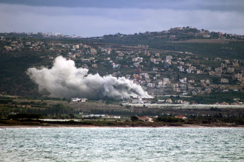 Smoke billows from the site of an Israeli strike that targeted the village of Mansouri in southern Lebanon's Tyre district on November 18, 2024. (Photo by Kawnat Haju / AFP)