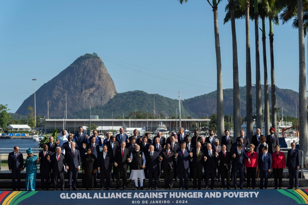 G20 leaders pose for a group photo at the G20 Summit in Rio de Janeiro, Brazil, on November 18, 2024. (Photo by Manuel Balce Ceneta / POOL / AFP)