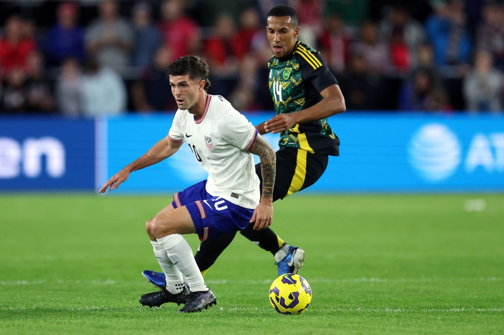 Christian Pulisic #10 of the United States and Isaac Hayden #14 of Jamaica compete for the ball during the 2024 Concacaf Nations League quarterfinal match at Citypark on November 18, 2024 in St Louis, Missouri. Jamie Squire/Getty Images/AFP