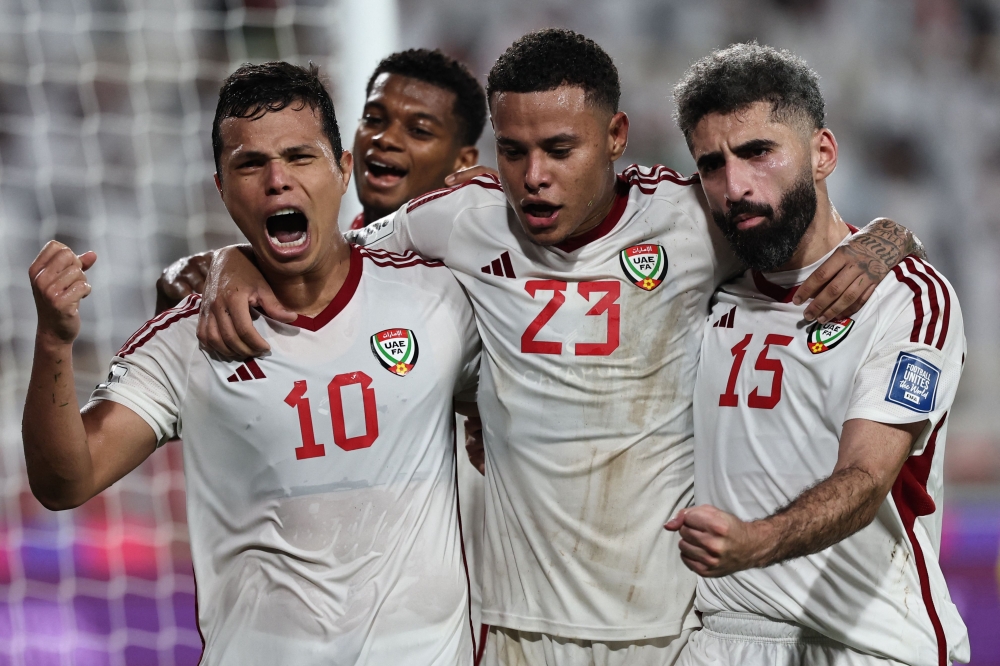 UAE's forward #10 Fabio de Lima celebrates with teammates after scoring a goal during the FIFA World Cup 2026 Asia zone qualifiers group A football match between UAE and Qatar at the Al-Nahyan Stadium in Abu Dhabi on November 19, 2024. (Photo by Fadel Senna / AFP)