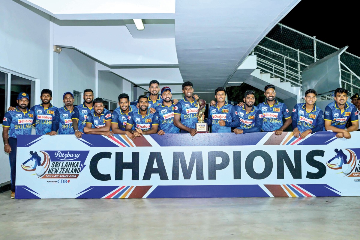 Sri Lanka’s players pose with the series trophy after winning the ODI series against the New Zealand 2-0 in Pallekele,  Kandy, yesterday.