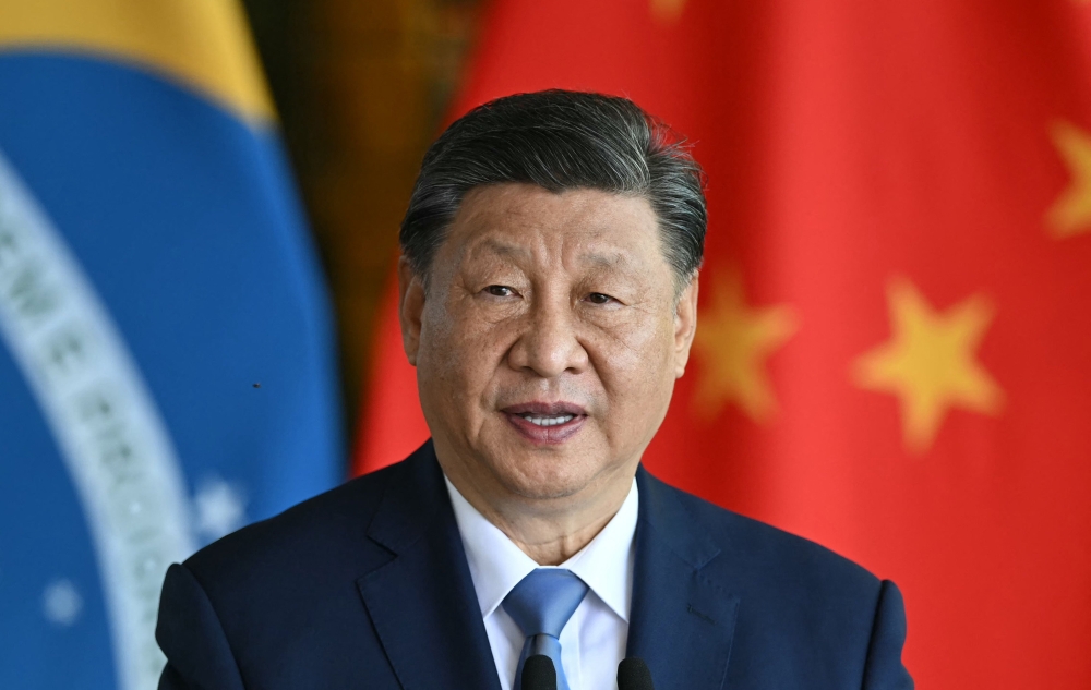 China's President Xi Jinping speaks as he and Brazil's President Luiz Inacio Lula da Silva give a joint statement to the press after a meeting at Planalto Palace in Brasilia on November 20, 2024. (Photo by Evaristo SA / AFP)