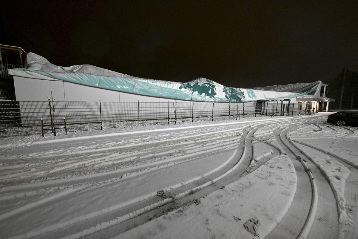 A collapsed sports hall is pictured after it caved in under the weight of wet snow in Espoo, Finland, on November 20, 2024, during Storm Jari. Photo by Vesa Moilanen / Lehtikuva / AFP