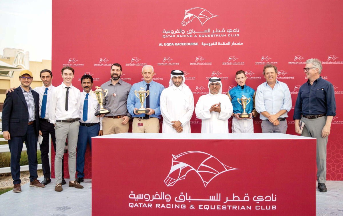 The connections of Dark Trooper celebrate with the trophies after winning the QA Gr3 Barzan Cup at Al Uqda Racecourse. QREC Racing Manager Abdulla Rashid Al Kubaisi crowned the winners. Pictures: Juhaim/QREC
