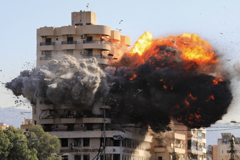 Fire and smoke erupt from a building just after an Israeli airstrike in Beirut's southern Shayah neighbourhood on November 22, 2024. (Photo by AFP)