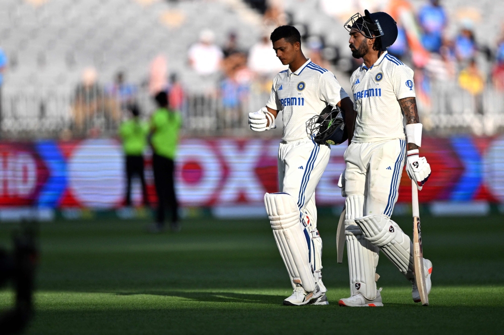 India's Yashasvi Jaiswal (L) and KL Rahul walk back to the pavilion at the end of the second day of the first Test cricket match between Australia and India on November 23, 2024. (Photo by Saeed Khan / AFP) 