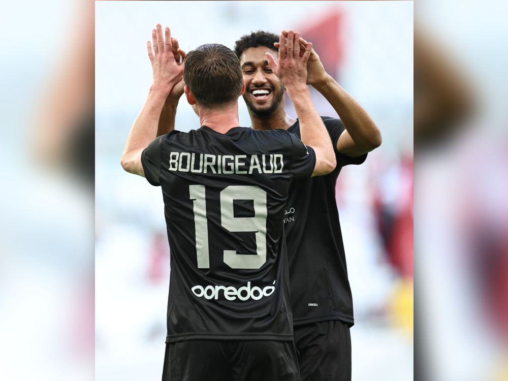 Al Duhail's Homam Al Amin (right) celebrates with teammate Benjamin Bourigeaud after scoring a goal against Al Arabi.