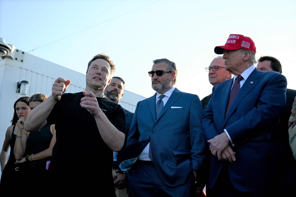 Elon Musk speaks with US President-elect Donald Trump and guests at a viewing of the launch of the sixth test flight of the SpaceX Starship rocket on November 19, 2024 in Brownsville, Texas. (Photo by Brandon Bell / Getty Images via AFP)