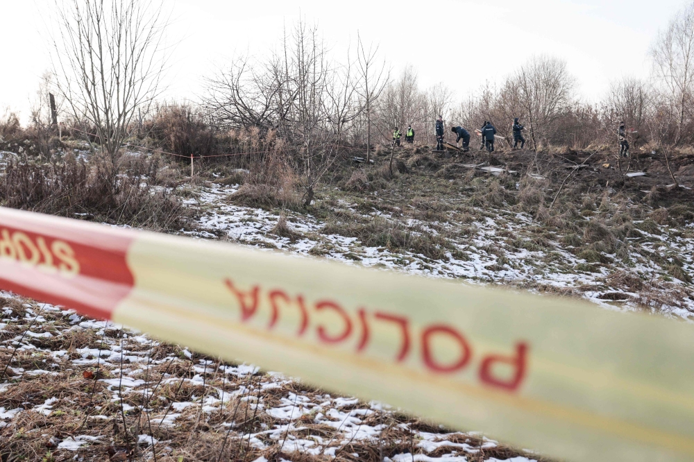 Lithuanian police search the area where a DHL cargo plane crashed near the Vilnius International Airport in Vilnius on November 25, 2024. Photo by Petras Malukas / AFP