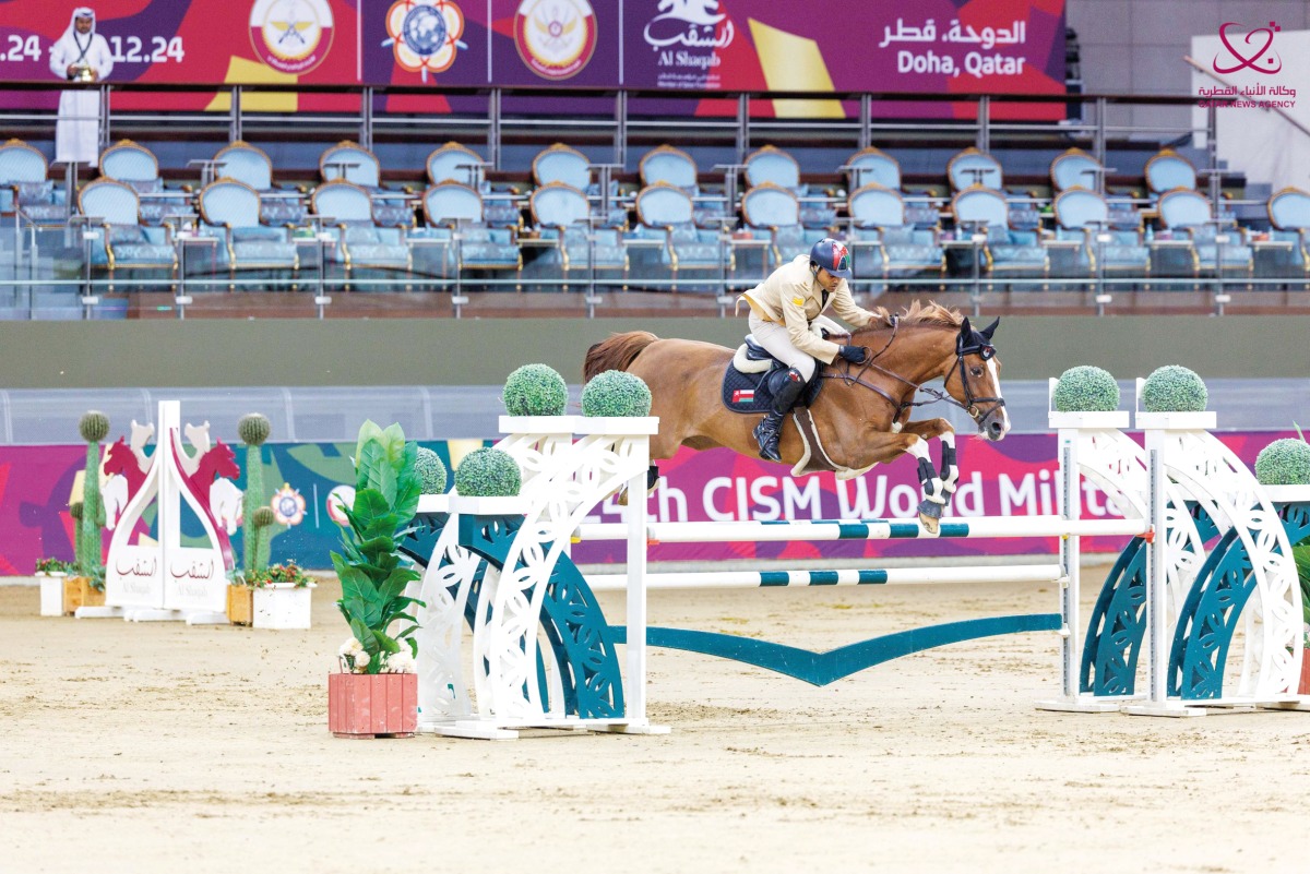 Oman’s Sgt. Madian Said Hamad Al Yusfi guides Hurry Up over a hurdle.