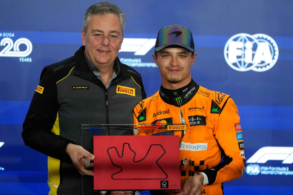 McLaren's British driver Lando Norris is presented with the Pirelli sprint qualifying award after the sprint qualifying session ahead of the Formula One Qatar Grand Prix at the Lusail International Circuit  on November 29, 2024. (Photo by Darko Bandic / POOL / AFP)