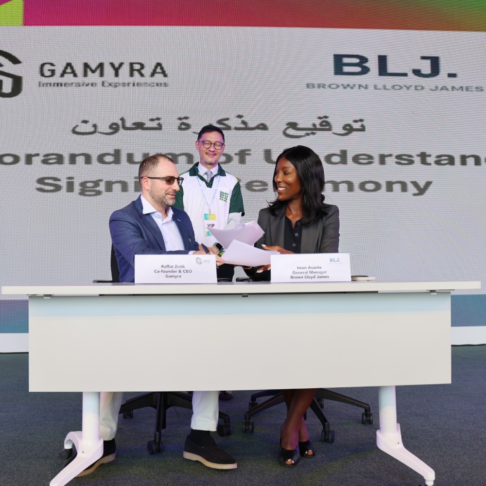 Raffat Zreik (left), Co-founder and CEO of Gamyra and Iman Asante, General Manager, BLJ Worldwide sign the MoU during QSTP AI Week 2024