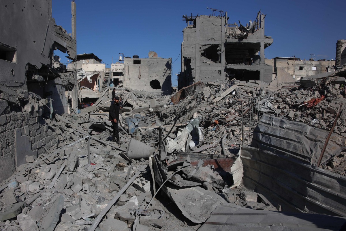 A Palestinian man stands amid the rubble of a building destroyed in an Israeli strike on the Shujaiyah neighbourhood in Gaza City in the northern Gaza Strip on November 30, 2024. (Photo by Omar AL-QATTAA / AFP)
