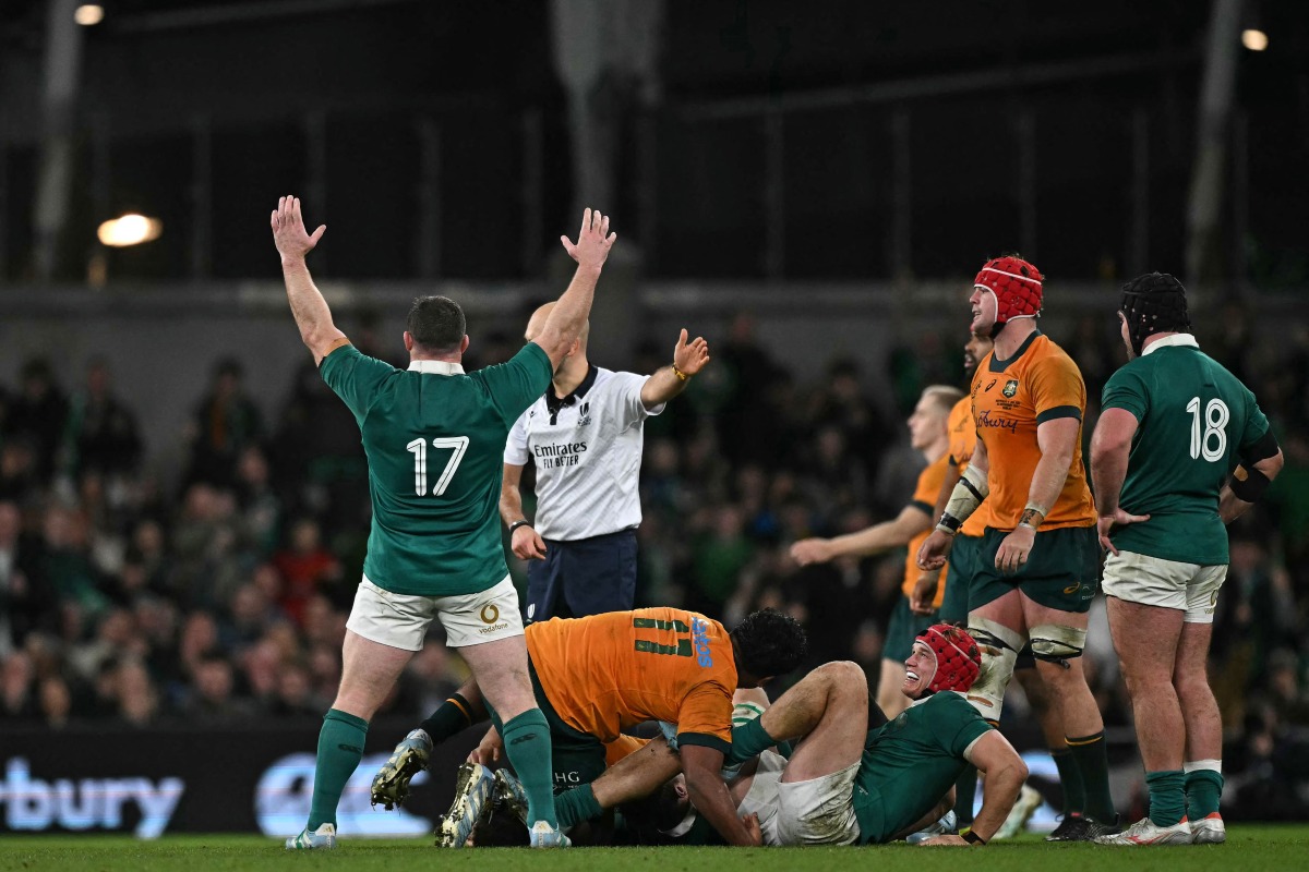 Ireland's prop Cian Healy (L) breaking Ireland's appearance record, celebrates on the final whistle in the International rugby union test match between Ireland and Australia at the Aviva Stadium in Dublin, on November 30, 2024. (Photo by Ben STANSALL / AFP)
