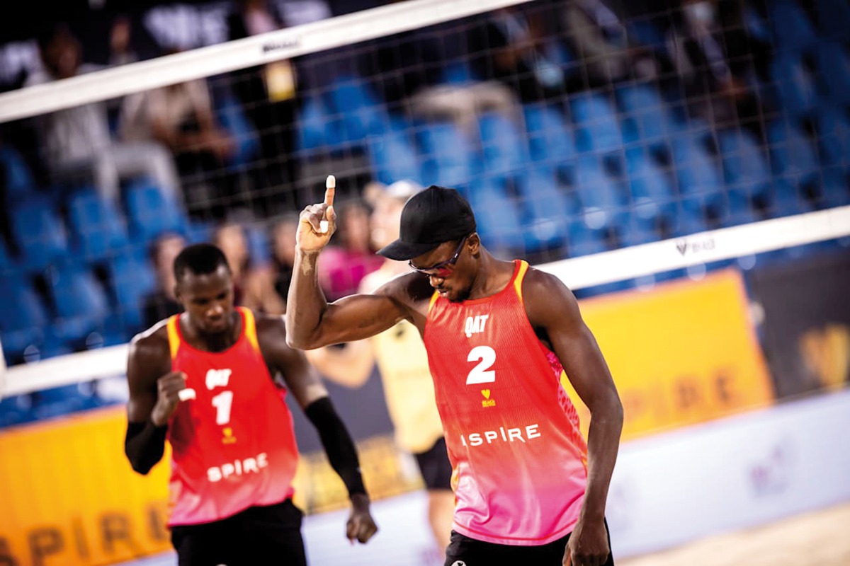 Qatar's Cherif Younousse (left) and Ahmed Tijan celebrate a point yesterday.