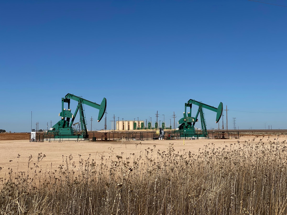 Pump jacks and storage tanks in the Permian Basin in western Texas.