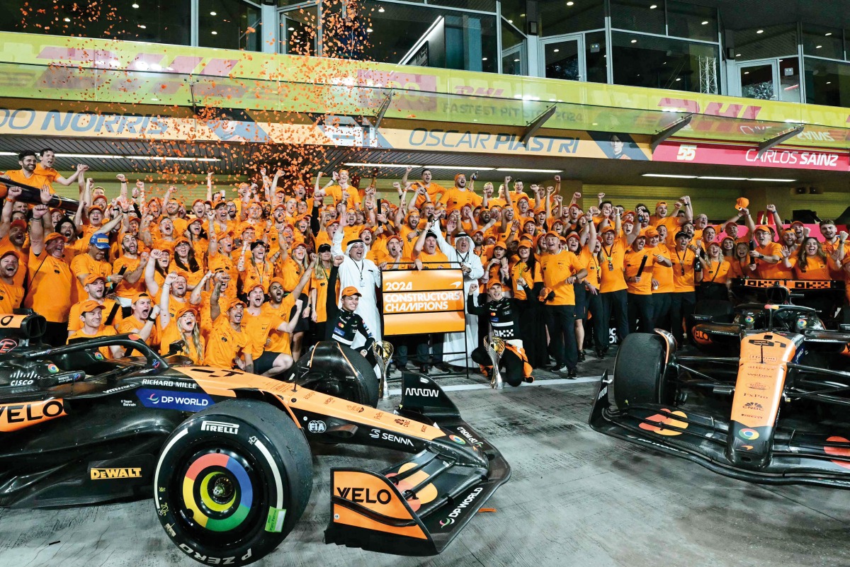 McLaren’s drivers Lando Norris and Oscar Piastri celebrate with their team members after winning constructor’s title.