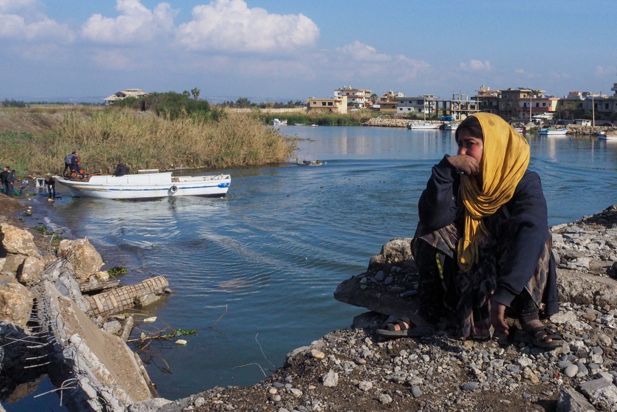 A Syrian refugee girl waits to cross the destroyed border between the two countries in Al-Arida on December 9, 2024, as they return to their homeland. (Photo by Ibrahim CHALHOUB / AFP)
