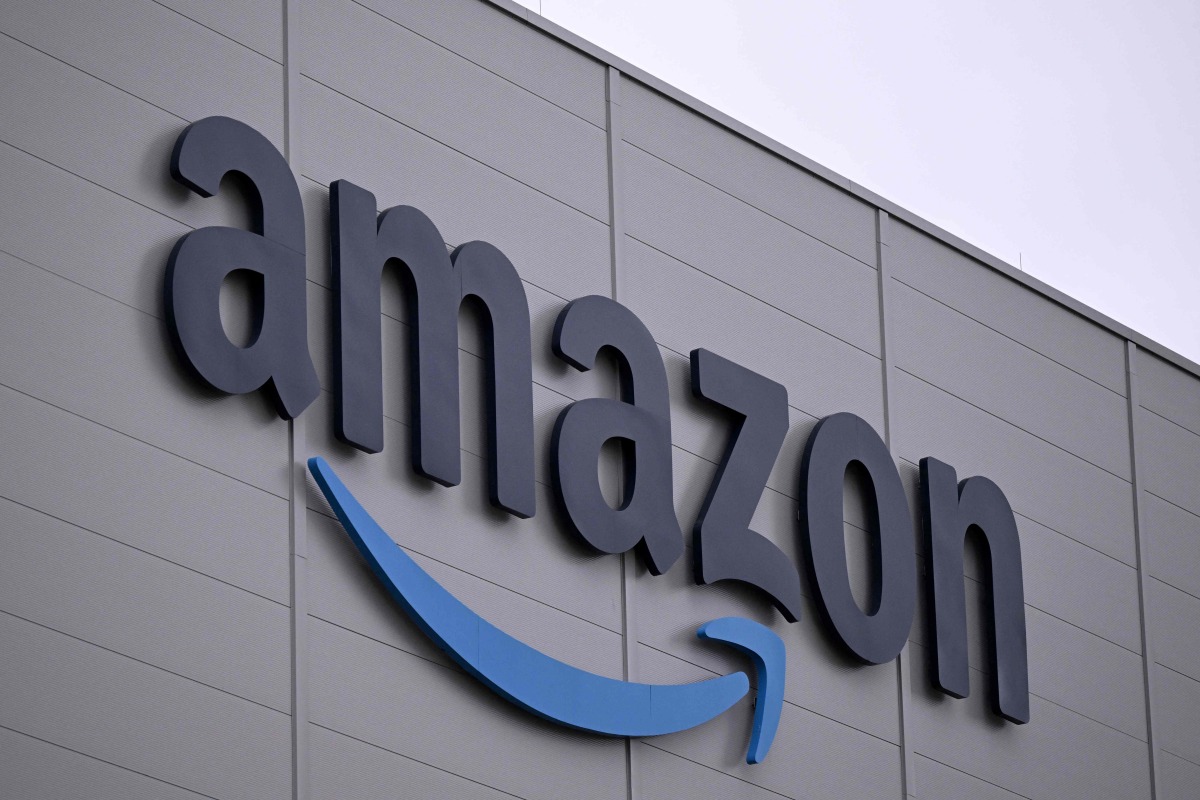 The logo of US online retail giant Amazon is seen on the facade of a redistribution centre in Horn-Bad Meinberg, western Germany, on December 9, 2024. (Photo by Ina FASSBENDER / AFP)